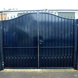 Wrought iron gate with black panelling