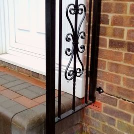  Filgree patterned wrought iron hand rail